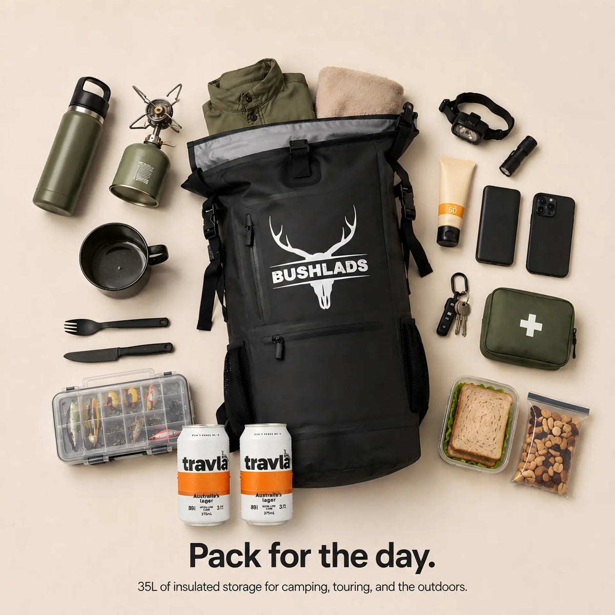 Bushlads 35L backpack laid flat surrounded by camping gear: camera, water bottle, cap, knife and tools
