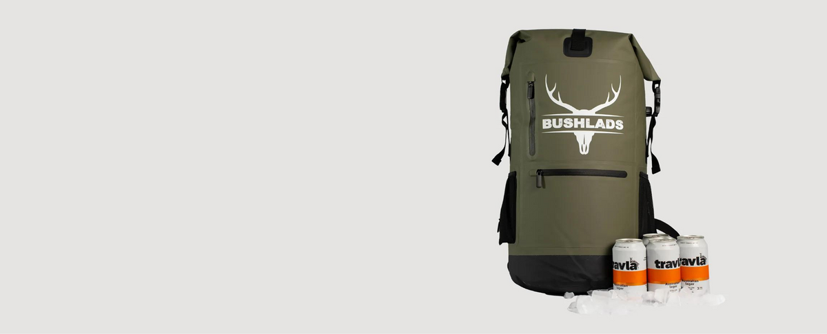 Olive Bushlads 35L backpack standing upright with chilled drinks beside it
