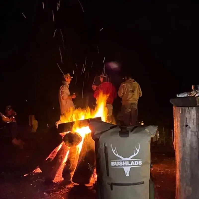 Bushlads pack beside a campfire at night
